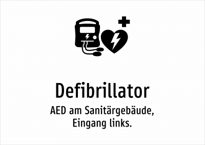 Defibrillator - AED am Sanitärgebäude, Eingang links.
