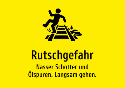 Rutschgefahr - Nasser Schotter und Ölspuren. Langsam gehen.